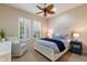 Guest bedroom with ceiling fan and comfortable seating area at 14333 Stirling Dr, Lakewood Ranch, FL 34202