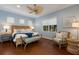 Peaceful bedroom with light blue walls, wicker furniture, and hardwood floors at 14333 Stirling Dr, Lakewood Ranch, FL 34202