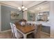 Elegant dining room with wood table and white chairs at 14333 Stirling Dr, Lakewood Ranch, FL 34202