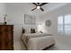 Guest bedroom with a queen bed and neutral decor at 14614 Newtonmore Ln, Lakewood Ranch, FL 34202