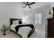 Guest bedroom with a double bed, dark wood dresser, and plantation shutters at 14614 Newtonmore Ln, Lakewood Ranch, FL 34202