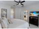 Spacious bedroom with large TV and access to another room at 14614 Newtonmore Ln, Lakewood Ranch, FL 34202