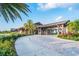 Community clubhouse entrance with palm trees and landscaping at 14614 Newtonmore Ln, Lakewood Ranch, FL 34202