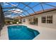 Relaxing screened pool with patio furniture, offering refreshing escape at 14614 Newtonmore Ln, Lakewood Ranch, FL 34202