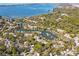 Aerial view showing waterfront homes, lush landscaping, and private boat docks at 1519 Pelican Point Dr # 191, Sarasota, FL 34231