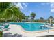 Inviting community pool with lounge chairs and tables at 1519 Pelican Point Dr # 191, Sarasota, FL 34231