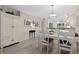 Charming dining area with white table and chairs, adjacent to kitchen at 1519 Pelican Point Dr # 191, Sarasota, FL 34231