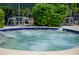 Inviting hot tub surrounded by lush greenery at 1519 Pelican Point Dr # 191, Sarasota, FL 34231