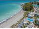 Aerial view of beachfront property with pool and lush landscaping at 1555 Tarpon Center Dr # 261, Venice, FL 34285