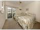 Bedroom with two twin beds and sliding door to balcony at 1555 Tarpon Center Dr # 261, Venice, FL 34285