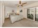 Main bedroom with king-size bed and sliding door to balcony at 1555 Tarpon Center Dr # 261, Venice, FL 34285