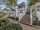 Exterior view showing building entrance with stairs and landscaping at 1555 Tarpon Center Dr # 261, Venice, FL 34285