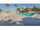 Community pool with lounge chairs and ocean view at 1555 Tarpon Center Dr # 261, Venice, FL 34285