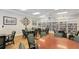 Relaxing community room with tables, chairs, and a large bookcase filled with books at 1910 Scarlett Ave, North Port, FL 34289