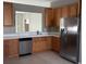 Modern kitchen with wood cabinets and stainless steel appliances at 1910 Scarlett Ave, North Port, FL 34289