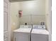 Laundry room with washer, dryer, and shelving at 1910 Scarlett Ave, North Port, FL 34289