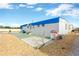 Rear view of a white mobile home with a covered patio and gravel landscaping at 2107 Palma Sola Blvd # 13, Bradenton, FL 34209