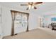 Living room with carpeted floors, a large window, and sliding glass door at 2107 Palma Sola Blvd # 13, Bradenton, FL 34209