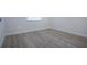 Empty bedroom with light gray vinyl flooring and a window at 2291 Pueblo Ln # V46, Sarasota, FL 34231