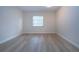 Simple bedroom with light walls and wood-look floors at 2291 Pueblo Ln # V46, Sarasota, FL 34231