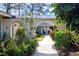 Inviting entryway with arched walkway and lush landscaping at 2291 Pueblo Ln # V46, Sarasota, FL 34231