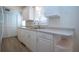 White kitchen with stainless steel sink and appliances at 2291 Pueblo Ln # V46, Sarasota, FL 34231