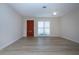 Spacious living room with wood-look floors and entry door at 2291 Pueblo Ln # V46, Sarasota, FL 34231