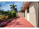 Private patio with red tile flooring and lush landscaping at 2291 Pueblo Ln # V46, Sarasota, FL 34231