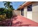 Red tile patio adjacent to the house with tropical landscaping at 2291 Pueblo Ln # V46, Sarasota, FL 34231