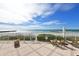 Relaxing beachfront patio with lounge chairs at 2301 Gulf Of Mexico Dr # 52N, Longboat Key, FL 34228