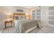 Well-lit bedroom with white walls and a plush bed at 2301 Gulf Of Mexico Dr # 52N, Longboat Key, FL 34228