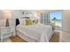 Coastal-themed bedroom with ocean views and comfy bedding at 2301 Gulf Of Mexico Dr # 52N, Longboat Key, FL 34228