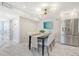 Bright dining area with marble floors and modern chandelier at 2301 Gulf Of Mexico Dr # 52N, Longboat Key, FL 34228