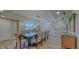 Elegant dining room with stone accent wall at 2301 Gulf Of Mexico Dr # 52N, Longboat Key, FL 34228