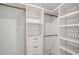 Spacious walk-in closet with ample shelving and hanging space at 2301 Gulf Of Mexico Dr # 52N, Longboat Key, FL 34228