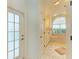 Spacious bathroom features a relaxing soaking tub, a frosted glass door, and a view at 232 Venice Palms Blvd, Venice, FL 34292