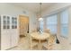 Breakfast nook with round table and chairs, near kitchen and entryway at 232 Venice Palms Blvd, Venice, FL 34292