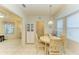 Breakfast nook with round table and chairs, near kitchen and entryway at 232 Venice Palms Blvd, Venice, FL 34292