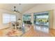 Dining area with hardwood floors and view of the pool and lanai at 232 Venice Palms Blvd, Venice, FL 34292