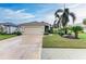 House exterior showcasing a two-car garage and manicured landscaping at 232 Venice Palms Blvd, Venice, FL 34292