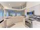 Modern kitchen with stainless steel appliances and view to backyard at 232 Venice Palms Blvd, Venice, FL 34292