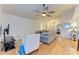 Comfortable living room featuring hardwood floors and a ceiling fan at 232 Venice Palms Blvd, Venice, FL 34292