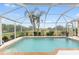 Inviting screened pool with a view of lush landscaping at 232 Venice Palms Blvd, Venice, FL 34292