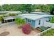 Cute light blue house with carport and tropical landscaping at 2335 Novus St, Sarasota, FL 34237