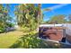 Backyard with a hot tub, tropical landscaping, and a playset at 2335 Novus St, Sarasota, FL 34237