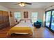 Bright bedroom with hardwood floors, and sliding door to backyard at 2335 Novus St, Sarasota, FL 34237