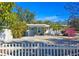 Front view of a charming house with a white picket fence at 2335 Novus St, Sarasota, FL 34237