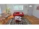 Mid-century modern living room with wood floors and red sofa at 2335 Novus St, Sarasota, FL 34237