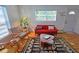 Mid-century modern living room with wood floors and red sofa at 2335 Novus St, Sarasota, FL 34237