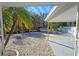 Covered patio area with gravel and tropical landscaping at 2335 Novus St, Sarasota, FL 34237